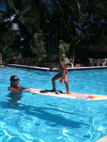 Hanalei practices surfing in the swimming pool in Praia da Pipa, Brazil